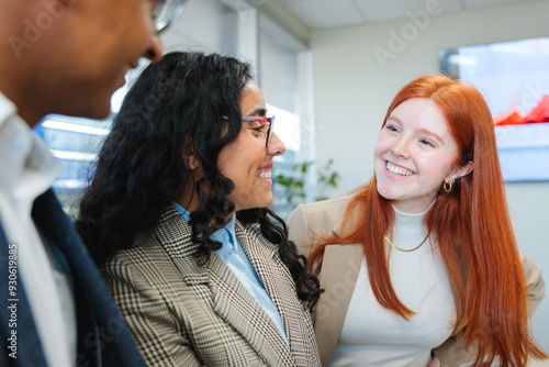 Close up of young smiling latin businesspeople team collaborating and doing business working in a meeting room office  photo