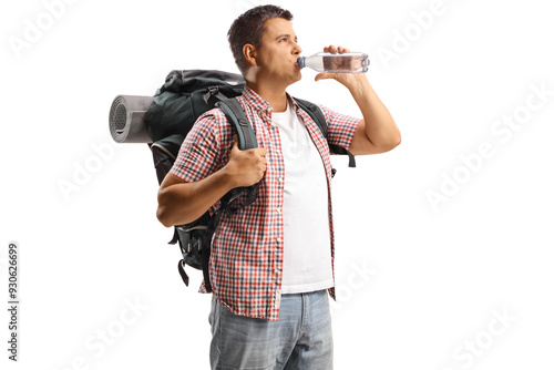 Male tourist with a backpack drinking water from a bottle photo