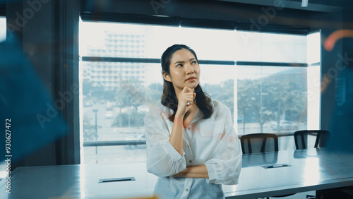 Beautiful female leader thinking about start up project in front of glass board. Smiling young project manager looking at colorful sticky notes with show creativity marketing strategy. Manipulator. Free Download Beautiful female leader thinking about start up project in front of glass board. Smiling young project manager looking at colorful sticky notes with show creativity marketing strategy. Manipulator. - GFXLoad