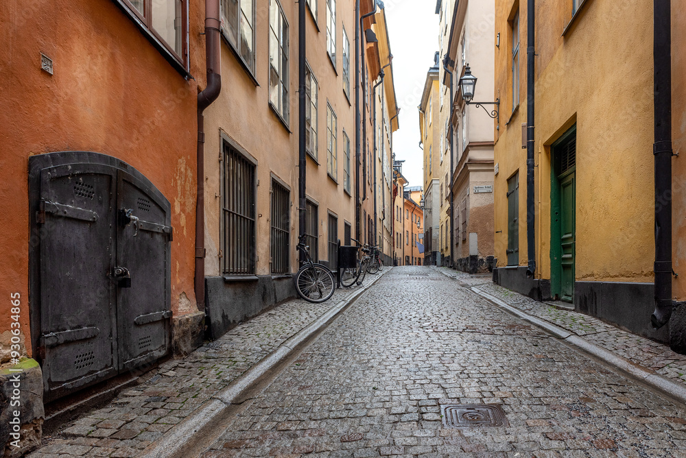 Sweden quaint cobblestone street in picturesque Gamla Stan, Stockholm's oldest neighborhood. Parked bicycles lean against the colorful plaster buildings.
Sweden quaint cobblestone street in picturesque Gamla Stan, Stockholm's oldest neighborhood. Parked bicycles lean against the colorful plaster buildings.
