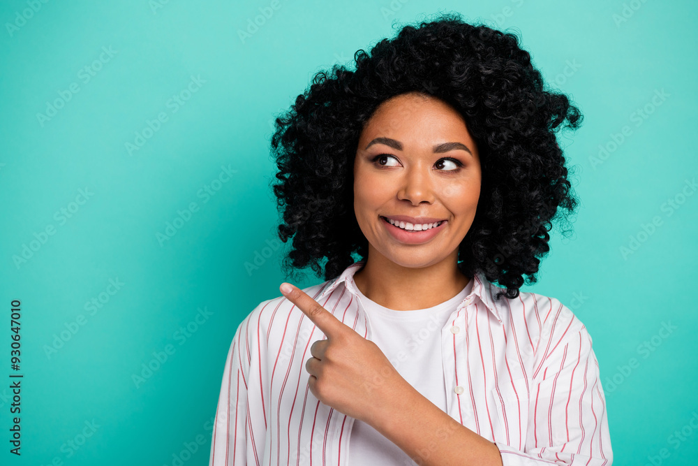 Photo of girlish pretty lady dressed white shirt looking showing finger empty space isolated teal color background Photo of girlish pretty lady dressed white shirt looking showing finger empty space isolated teal color background