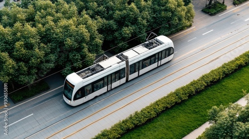 A white light rail train travels along a smooth highway, bordered by trees, in the bustling city of Shenzhen, showcasing the harmony of urban transit and nature