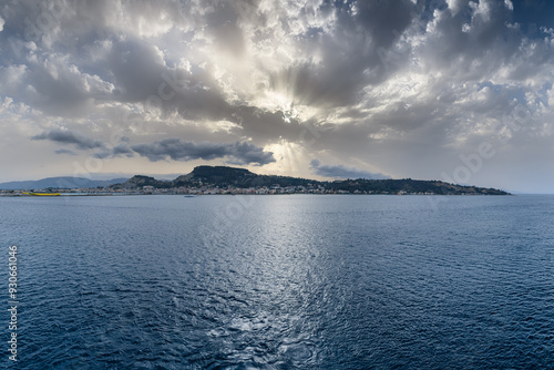 Townscape of Zakynthos with sun between clouds in Greece. photo