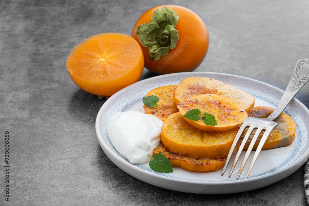 Pieces of baked caramelized persimmon on gray background Pieces of baked caramelized persimmon on gray background