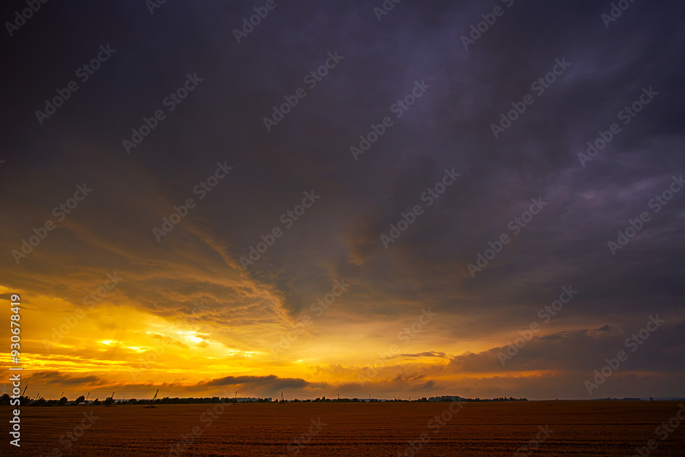Dramatic sunset thunderstorm sky over an open field Dramatic sunset thunderstorm sky over an open field