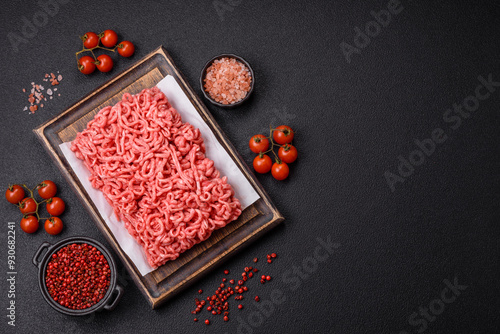 Fresh raw ground beef with salt and spices photo