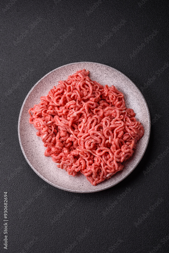 Fresh raw ground beef with salt and spices Fresh raw ground beef with salt and spices