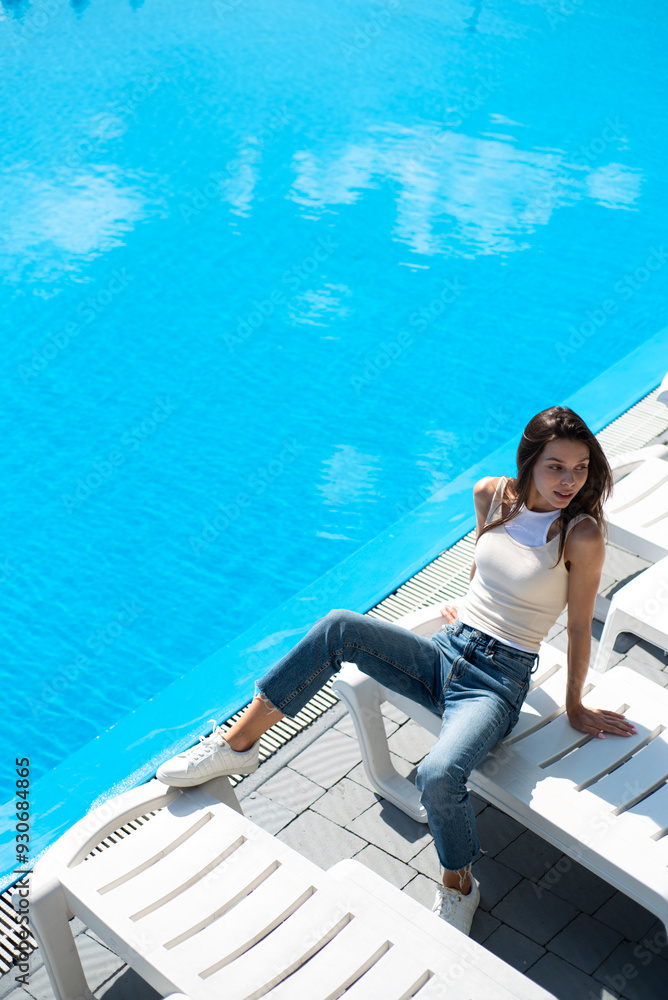 pretty young girl in jeans in the summer pool pretty young girl in jeans in the summer pool