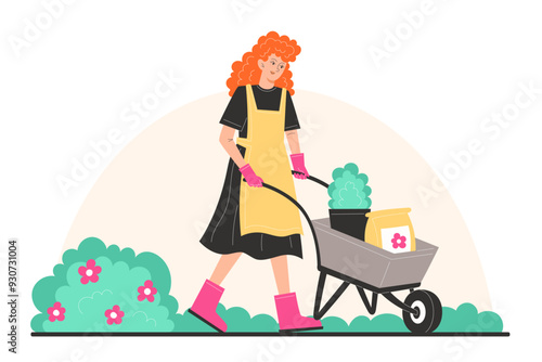 A young woman in garden clothes is carrying a cart with potted plants and fertilizer