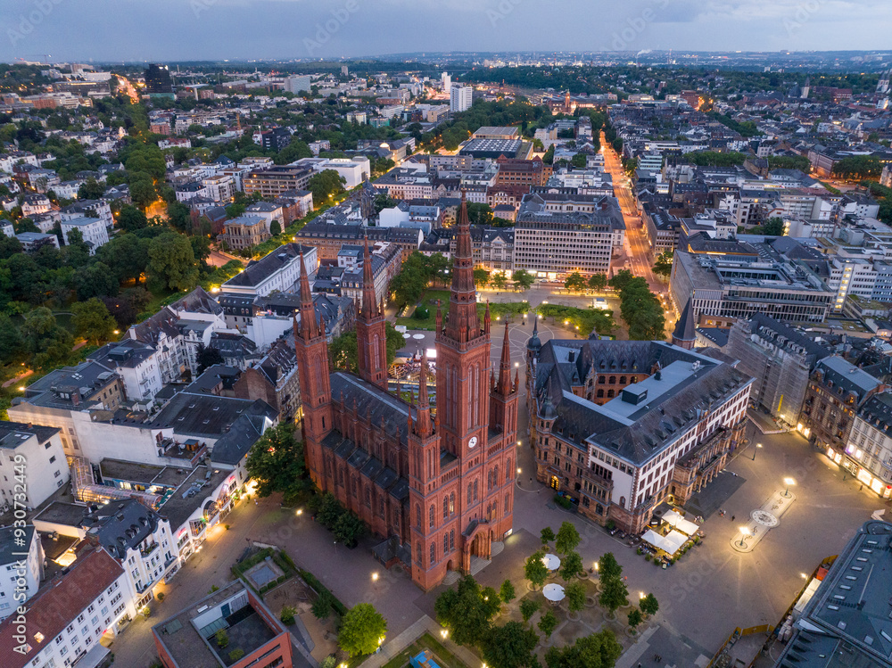 Naklejka premium Aerial Drone Shot of Cathedral at Marktkirche in Wiesbaden, Germany. Old town and the city center at Evening Twilight.