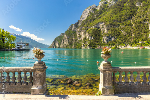 Lake Garda with mountains in background, view from Riva del Garda town shore, Italy, Europe. photo