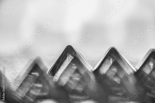 Close-up macro of sewing studs arranged in symmetrical rows in black and white abstraction abstract photo