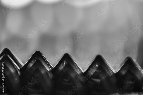 Close-up macro of sewing studs arranged in symmetrical rows in black and white abstraction abstract photo