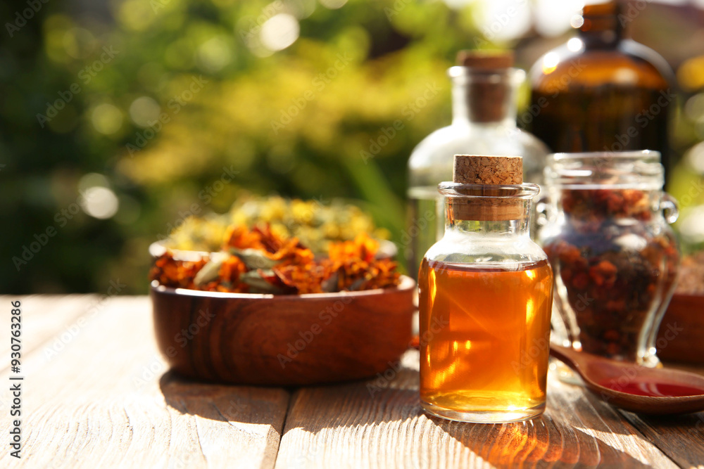 Different tinctures and ingredients on wooden table outdoors Different tinctures and ingredients on wooden table outdoors