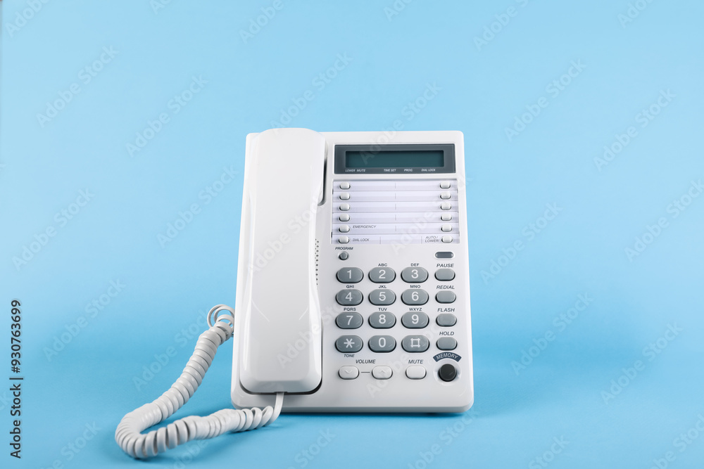 White telephone with handset on light blue background White telephone with handset on light blue background