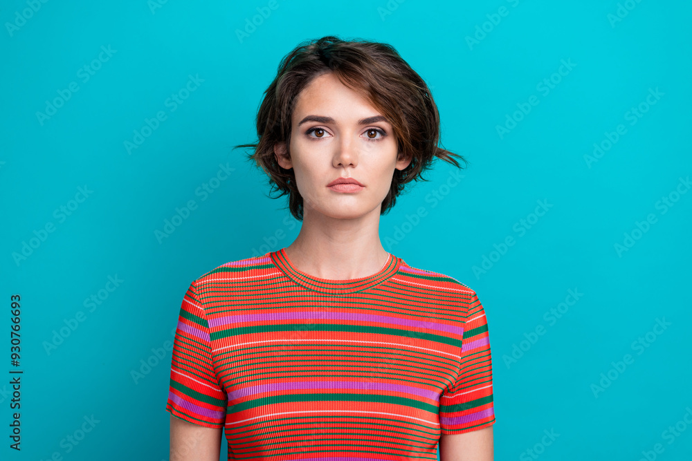 Fototapeta premium Photo of serious gorgeous woman with short hairstyle dressed striped t-shirt look at camera isolated on turquoise color background