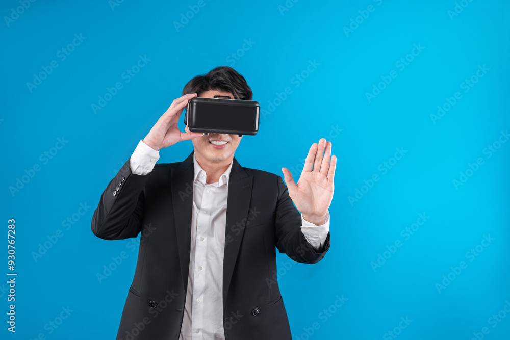 Asian businessman looking thorough VR while touching screen with connecting business world report in futuristic metaverse analyzing innovation technology virtual reality blue copyspace. Contrivance. Asian businessman looking thorough VR while touching screen with connecting business world report in futuristic metaverse analyzing innovation technology virtual reality blue copyspace. Contrivance.