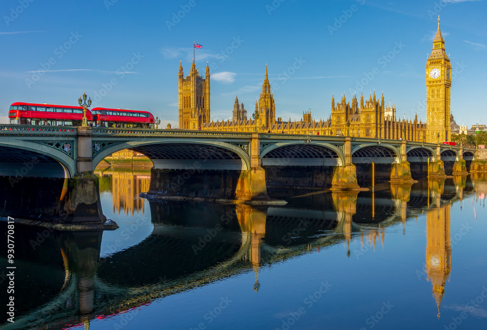 Naklejka premium Houses of parliament with Big Ben tower and Westminster bridge reflected in Thames river, London, UK