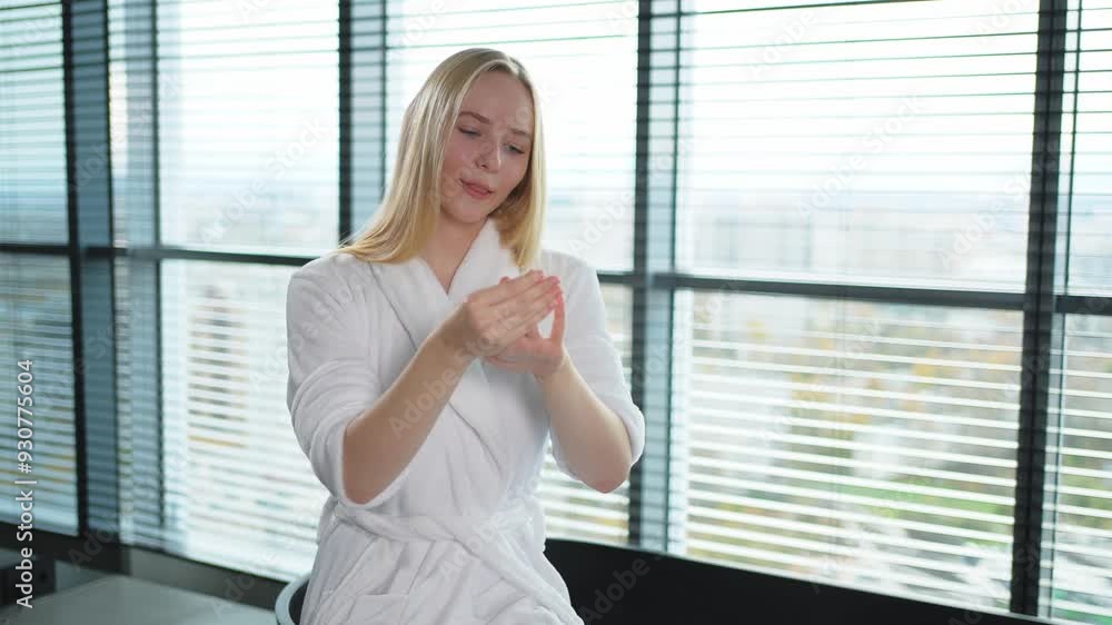 Woman applying moisturizing body lotion on hand arm relaxing in bathroom. Girl rubbing nourishing cream doing daily skincare routine spending morning in bathroom. Beauty treatment spa body skin care Woman applying moisturizing body lotion on hand arm relaxing in bathroom. Girl rubbing nourishing cream doing daily skincare routine spending morning in bathroom. Beauty treatment spa body skin care