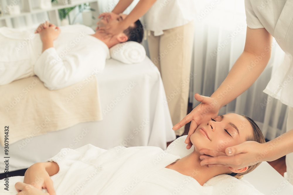 Caucasian couple enjoying relaxing anti-stress head massage and pampering facial beauty skin recreation leisure in dayspa modern light ambient at luxury resort or hotel spa salon. Quiescent Caucasian couple enjoying relaxing anti-stress head massage and pampering facial beauty skin recreation leisure in dayspa modern light ambient at luxury resort or hotel spa salon. Quiescent