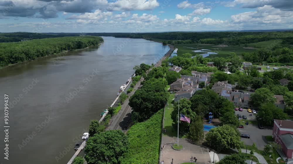 view of river and public park in hudson new york with distant mountains and marsh (small town downtown train tracks station) promenade hill scenic drone view footage view of river and public park in hudson new york with distant mountains and marsh (small town downtown train tracks station) promenade hill scenic drone view footage