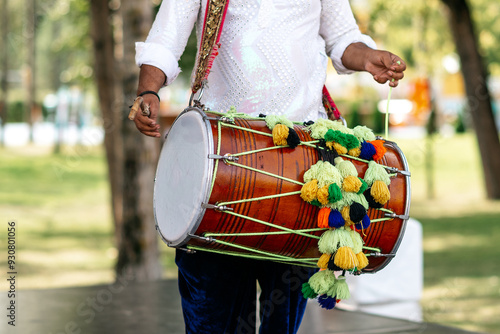 A man at an Indian festival plays a drum. photo