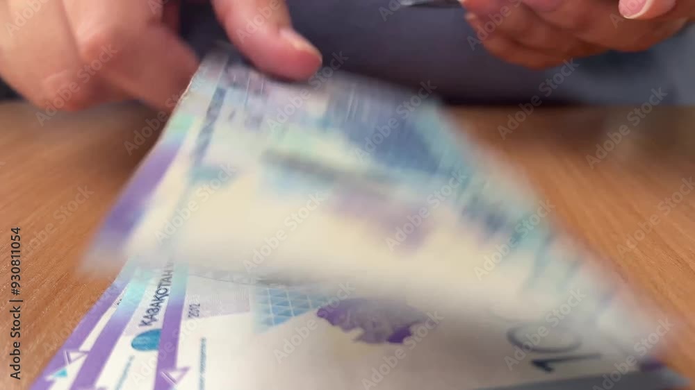 Front view. 4K video close up. White woman counts paper banknotes of 10000 tenge of Kazakhstan. Cash money. Bill. Vacation, travel, tourism, trip, currency exchange, mortgage, salary, job, tax, budget Front view. 4K video close up. White woman counts paper banknotes of 10000 tenge of Kazakhstan. Cash money. Bill. Vacation, travel, tourism, trip, currency exchange, mortgage, salary, job, tax, budget