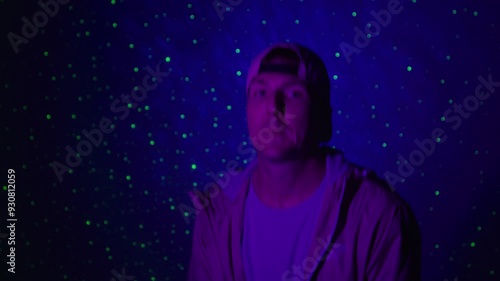 Rap artist singing for a music video on a space background