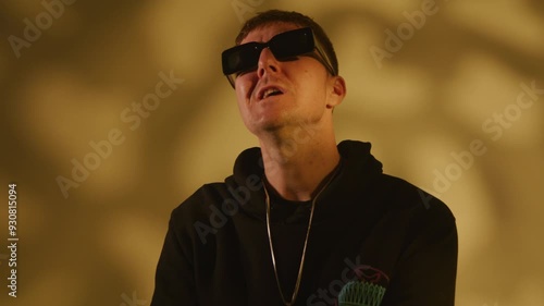 Rap artist singing for a music video on a warm textured background