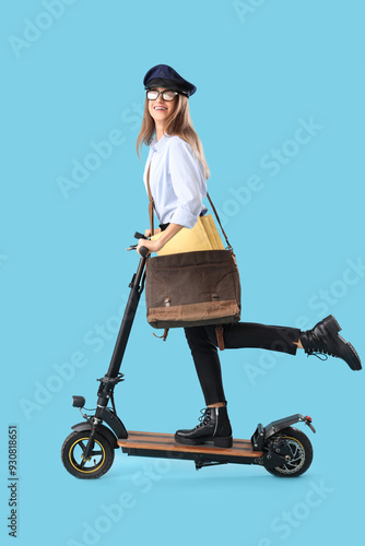 Young postwoman riding elec...