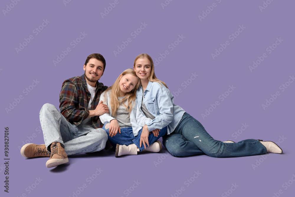 Happy family in stylish denim clothes sitting on purple background Happy family in stylish denim clothes sitting on purple background