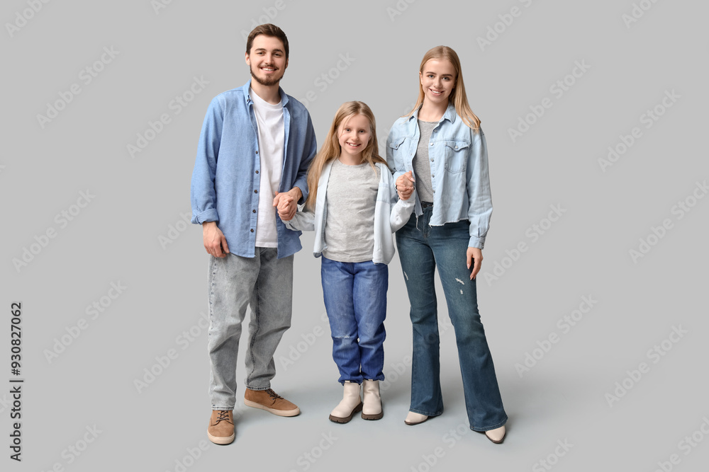 Fototapeta premium Happy family in stylish denim clothes on grey background