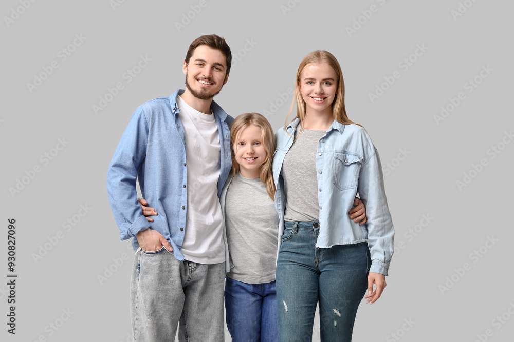 Happy family in stylish denim clothes on grey background Happy family in stylish denim clothes on grey background