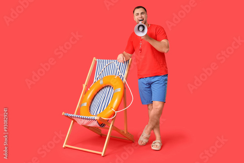 Happy young lifeguard with ...