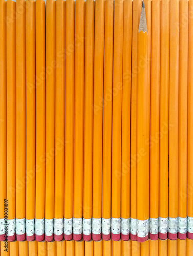Orange pencils vertical background with one sharpened pencil for back to school and education concept.