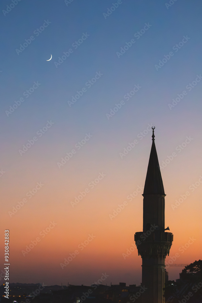 A stunning silhouette of a mosque's minaret against the evening sky, illuminated by the soft glow of the moon and stars during Ramadan. A stunning silhouette of a mosque's minaret against the evening sky, illuminated by the soft glow of the moon and stars during Ramadan.