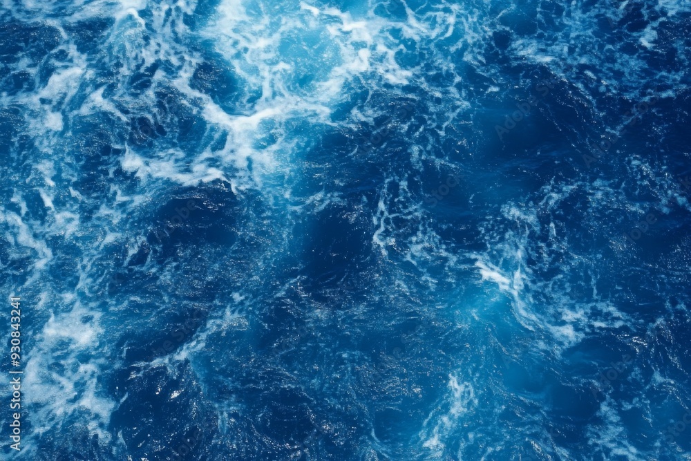 Top view of blue ocean water with intricate wave textures and water splashes, creating an abstract background of the sea surface, showcasing the dynamic movement and vibrant blue tones of the ocean. Top view of blue ocean water with intricate wave textures and water splashes, creating an abstract background of the sea surface, showcasing the dynamic movement and vibrant blue tones of the ocean.