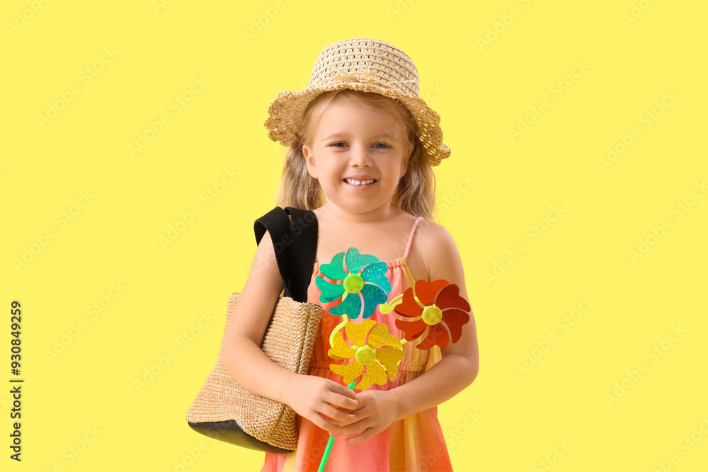 Cute little girl with toy windmill on yellow background Cute little girl with toy windmill on yellow background