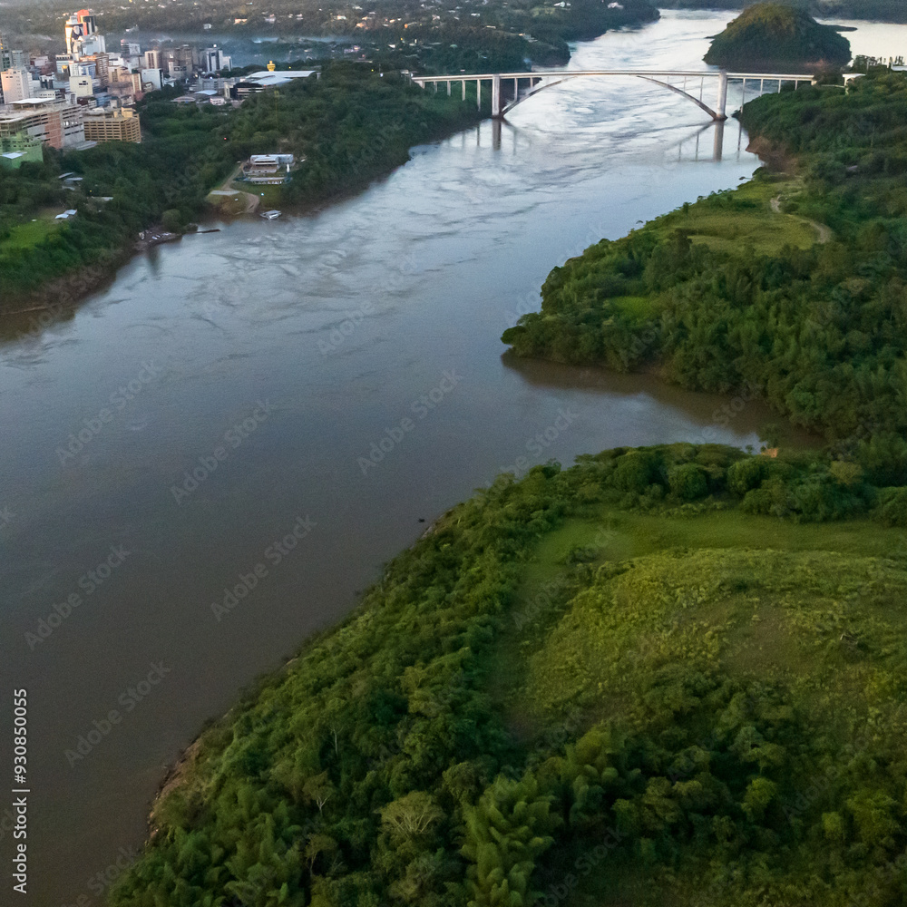 Border between Brazil and Paraguay and connects Foz do Iguacu to Ciudad del Este. Ponte da Amizade in Foz do Iguacu. Aerial view of the Friendship Bridge with Parana river. Border between Brazil and Paraguay and connects Foz do Iguacu to Ciudad del Este. Ponte da Amizade in Foz do Iguacu. Aerial view of the Friendship Bridge with Parana river.
