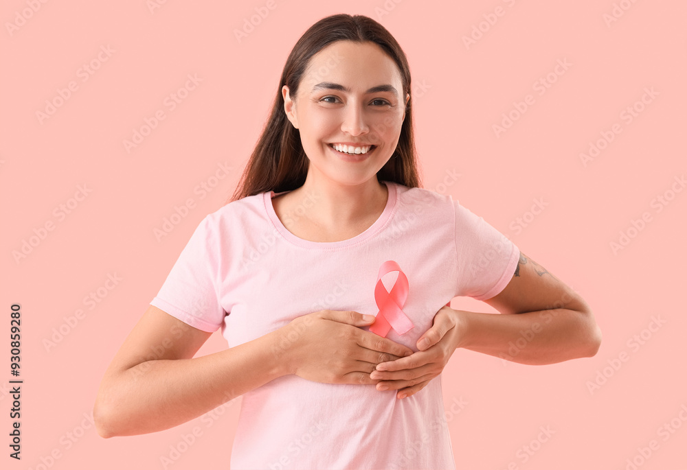 Young woman with pink ribbon on color background. Breast cancer awareness concept Young woman with pink ribbon on color background. Breast cancer awareness concept