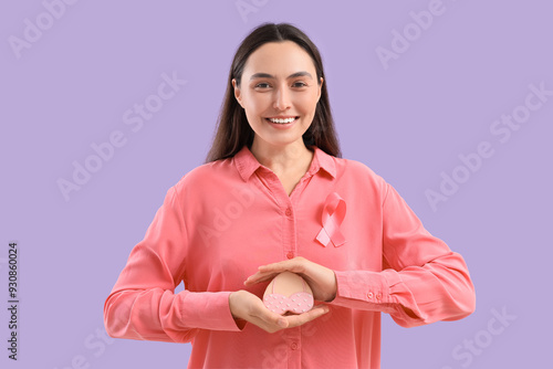Young woman with pink ribbo...