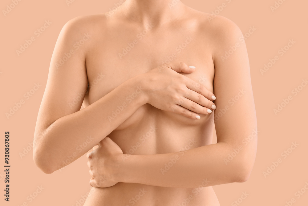 Naked woman on beige background, closeup. Breast cancer awareness concept Naked woman on beige background, closeup. Breast cancer awareness concept