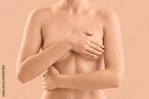 Naked woman on beige backgr...