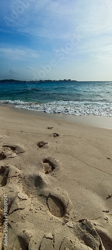 Johnny Cay Beach, San Andres Islands footprints of a person on the sand in front of the sea photo