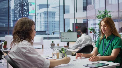 Recruiter rejecting an unqualified job candidate during the selection process, writes the refusal on their resume. HR team not pleased with unsuitable unprepared applicants, CV evaluation. Camera B.