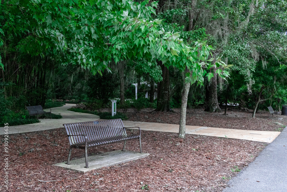 Empty park bench with gazebo in background Empty park bench with gazebo in background