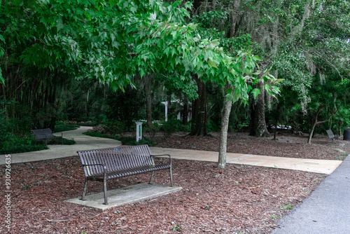 Empty park bench with gazebo in background