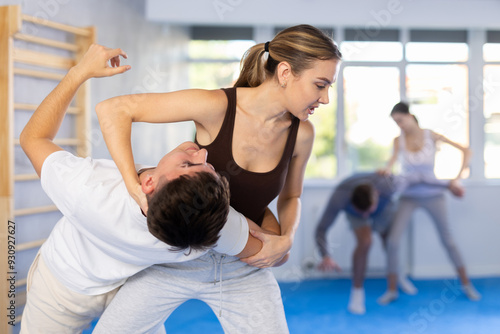 Cuadro en lienzo Practiced young female practitioner of self-defense classes demonstrating throw