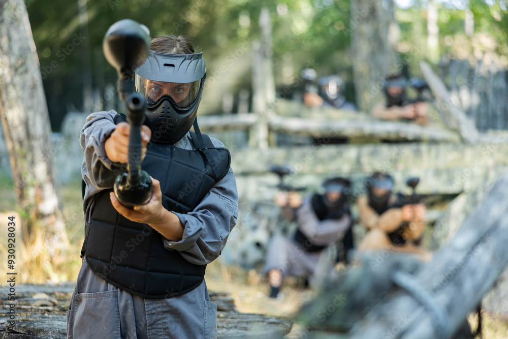 Fototapeta premium Paintball player recklessly aims with a gun on the battlefield