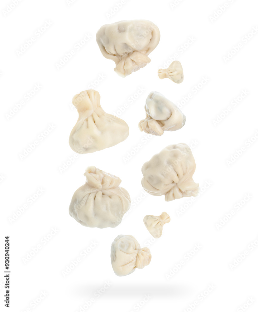 Fototapeta premium Delicious khinkali (Georgian dumplings) falling on white background